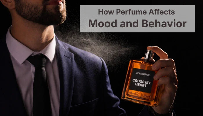 A man with a beard wearing a formal suit and tie sprays a mist of Scentories "Cross My Heart" perfume, illustrating How Perfume Affects Mood and Behavior.